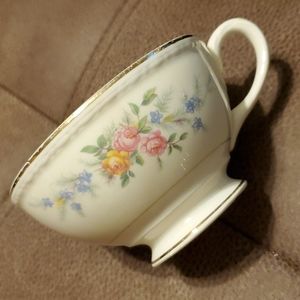 Vintage tea cup with roses, gold trim